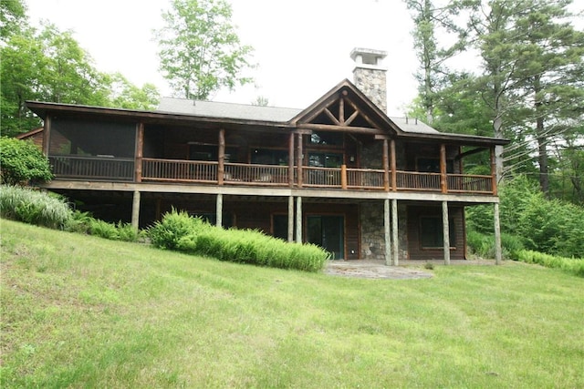 rear view of property featuring a lawn and a patio