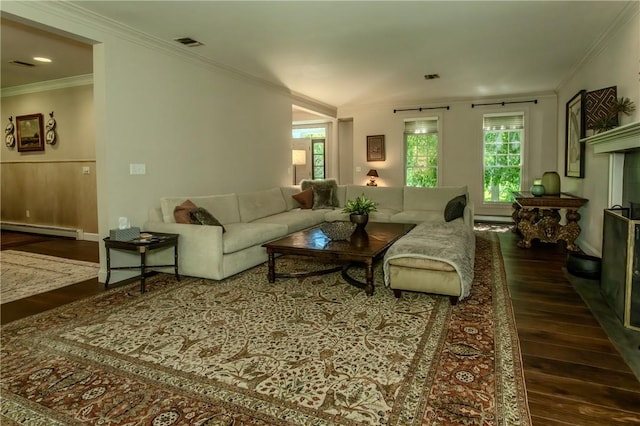 living room with dark hardwood / wood-style floors, baseboard heating, and crown molding