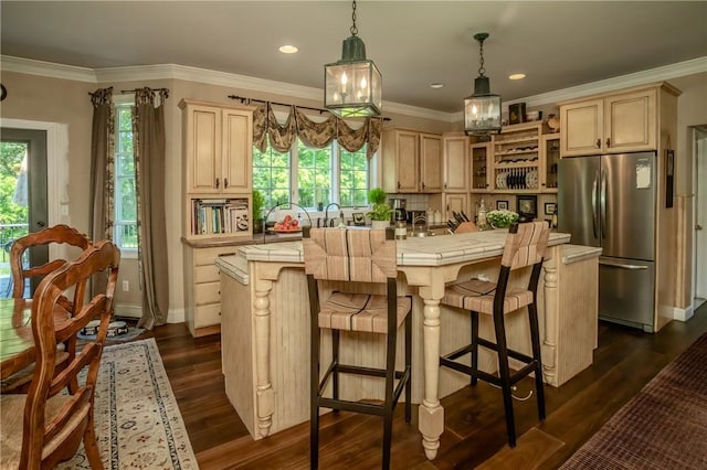 kitchen featuring stainless steel fridge, a center island, dark hardwood / wood-style flooring, and plenty of natural light