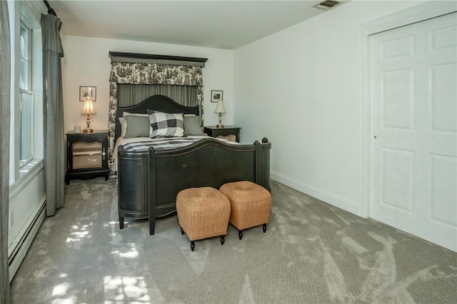 bedroom with carpet and a baseboard radiator