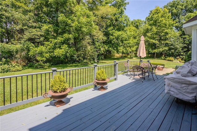 wooden deck featuring a lawn