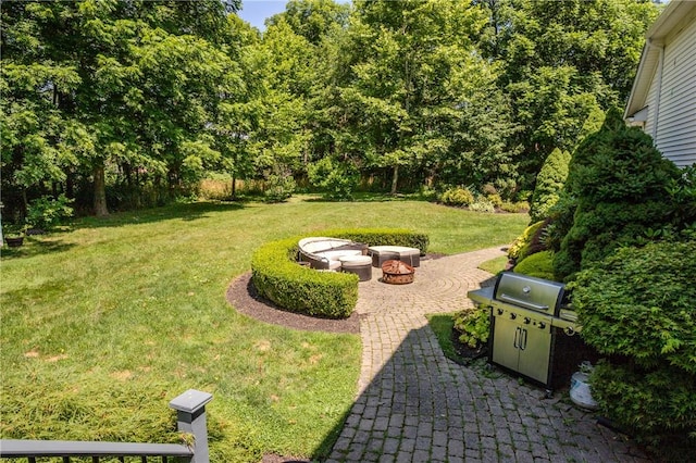 view of yard featuring a fire pit and a patio