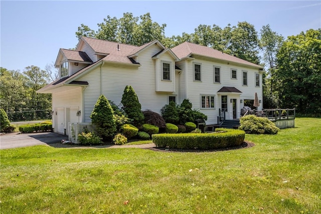 view of front of house featuring a garage and a front yard