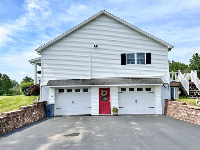 exterior space with a garage and central air condition unit