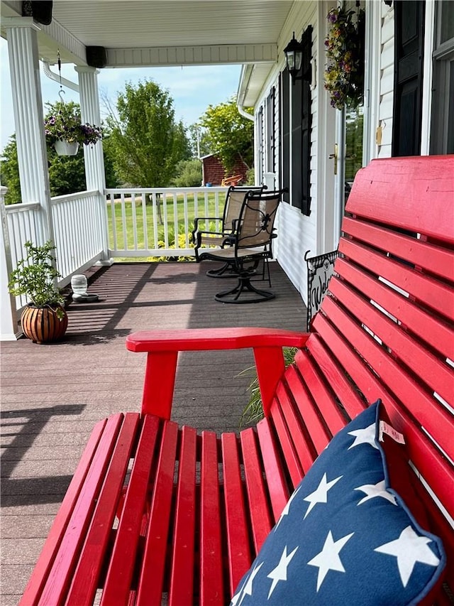 wooden terrace featuring covered porch