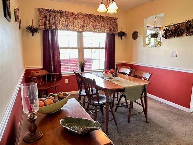 carpeted dining space with a notable chandelier