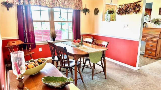 dining area featuring plenty of natural light and light colored carpet