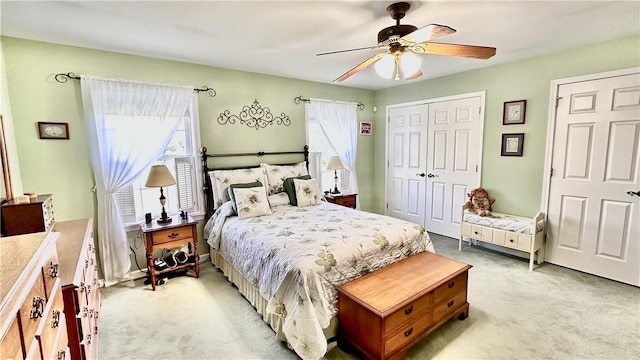 bedroom featuring ceiling fan and light carpet