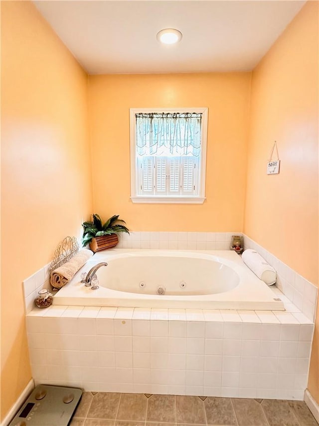 bathroom with tile patterned flooring and tiled tub