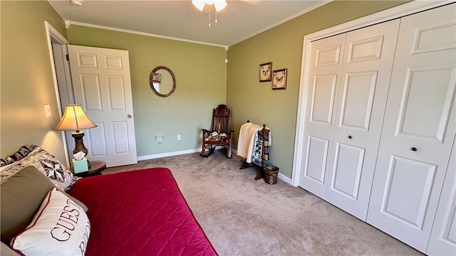 carpeted bedroom featuring crown molding and a closet