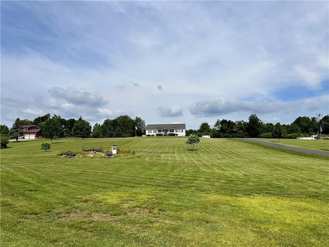 view of home's community featuring a lawn and a rural view