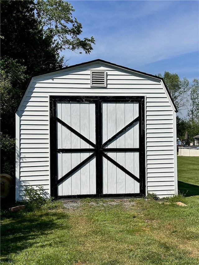 view of outbuilding with a yard