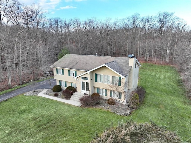 split foyer home with a front lawn