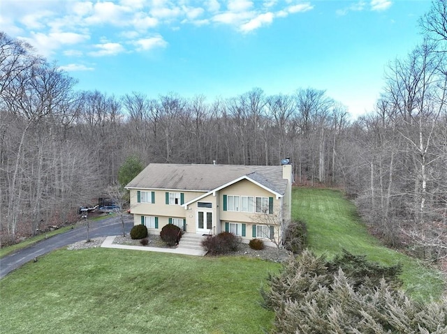 raised ranch featuring a front yard