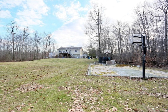 view of yard with basketball hoop