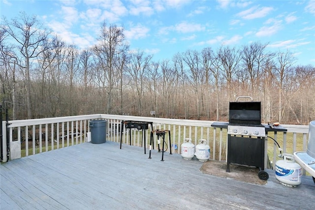 wooden terrace with a grill