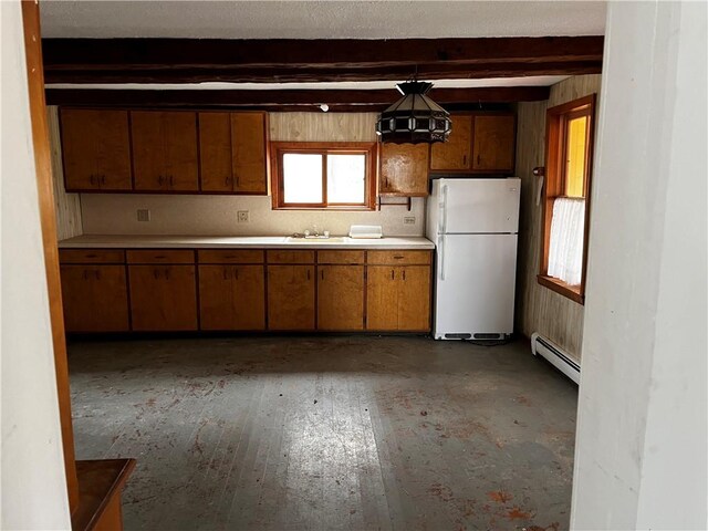 kitchen with dark wood-type flooring, baseboard heating, beamed ceiling, white fridge, and pendant lighting