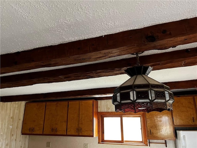 room details with beam ceiling and a textured ceiling