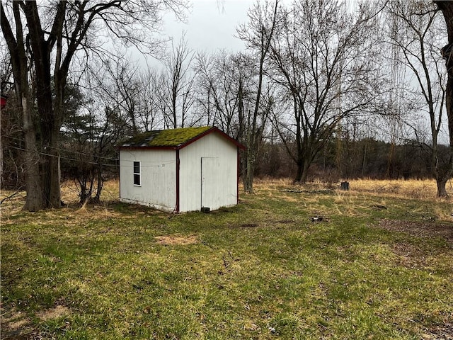 view of outbuilding featuring a yard