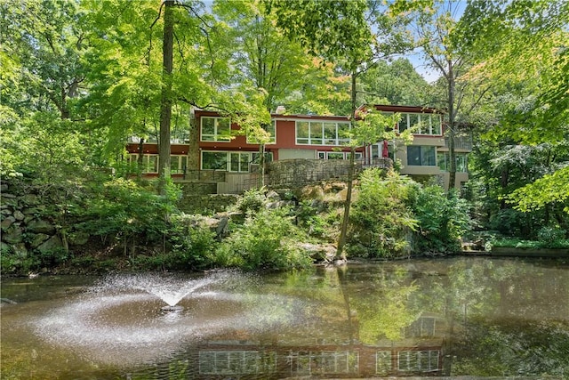 back of property with a water view