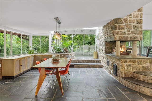 sunroom with a stone fireplace