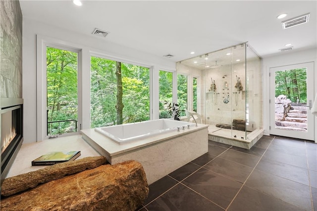 bathroom featuring tile patterned floors, separate shower and tub, and plenty of natural light