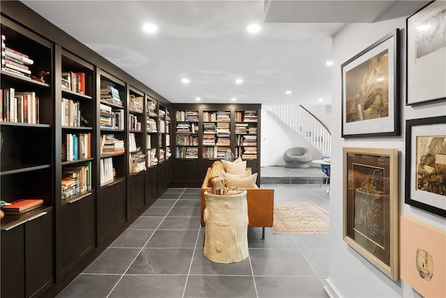 living area featuring dark tile patterned flooring