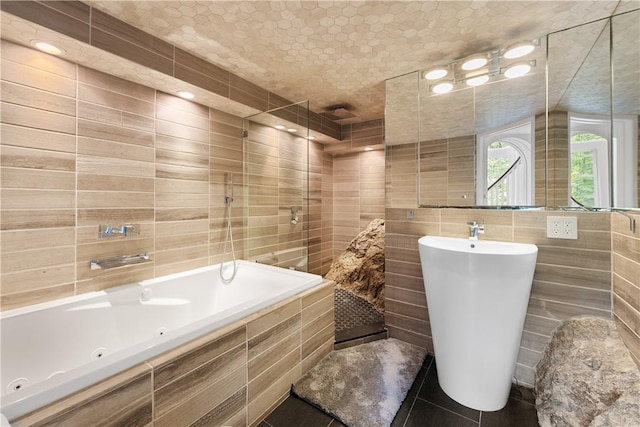 bathroom with independent shower and bath and tile walls