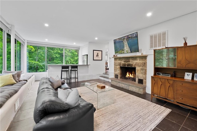 living room with a fireplace and tile patterned flooring