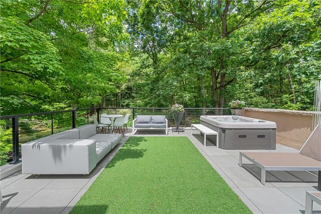 view of yard featuring an outdoor living space, a patio, and a hot tub