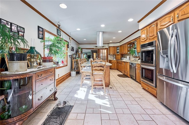 kitchen featuring a center island, backsplash, crown molding, appliances with stainless steel finishes, and a kitchen bar