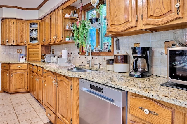 kitchen featuring stainless steel dishwasher, light stone counters, crown molding, and sink