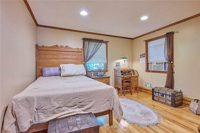 bedroom featuring crown molding and light hardwood / wood-style flooring