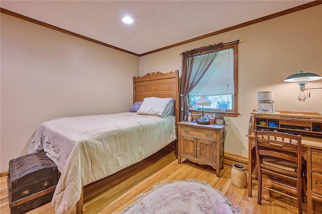 bedroom featuring ornamental molding and light wood-type flooring