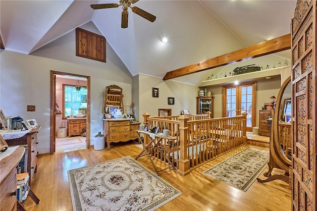 interior space with ceiling fan, high vaulted ceiling, and light hardwood / wood-style flooring