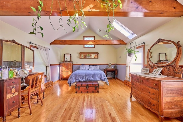 bedroom with vaulted ceiling with skylight and light wood-type flooring