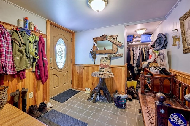 entryway featuring crown molding and wood walls