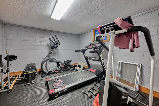 exercise room with a textured ceiling