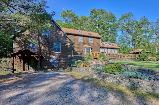 back of house featuring a deck