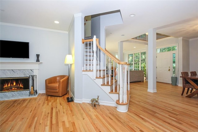 interior space featuring ornamental molding, wood finished floors, and baseboards