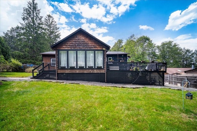 back of house featuring a yard and a wooden deck