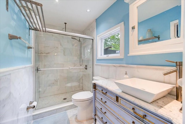 bathroom with tile patterned flooring, vanity, toilet, and a shower with door