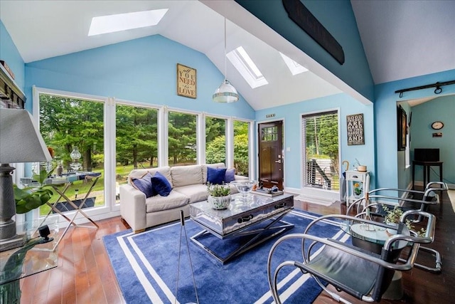 sunroom featuring lofted ceiling with skylight