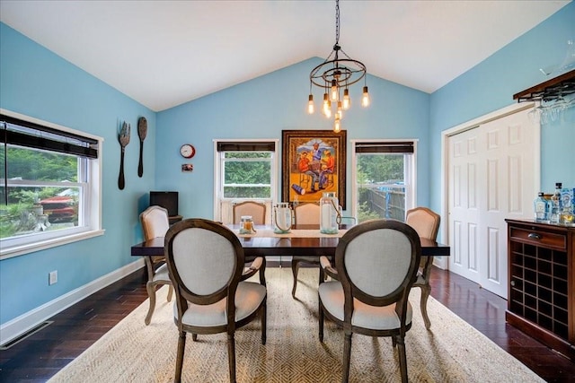 dining room featuring plenty of natural light, dark hardwood / wood-style flooring, and lofted ceiling