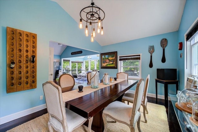 dining room featuring a chandelier, dark hardwood / wood-style floors, and lofted ceiling