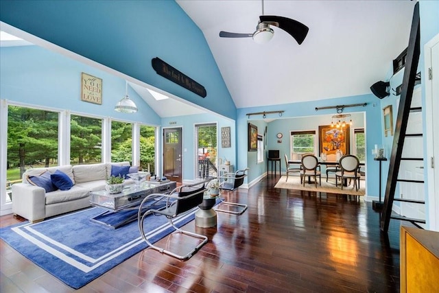 living room featuring dark hardwood / wood-style floors, high vaulted ceiling, plenty of natural light, and ceiling fan