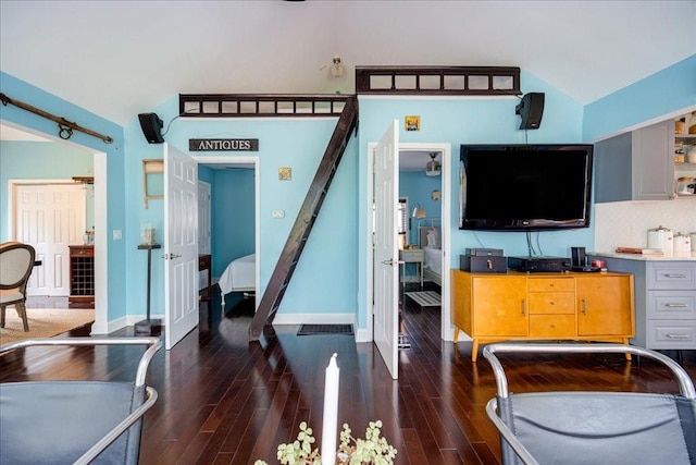 bedroom featuring dark wood-type flooring and vaulted ceiling