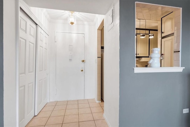 hall with light tile patterned floors and crown molding