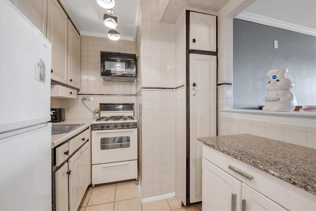 kitchen with tasteful backsplash, light tile patterned floors, white appliances, and ornamental molding