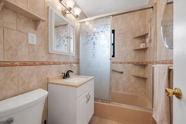 full bathroom featuring vanity, toilet, tile walls, and enclosed tub / shower combo